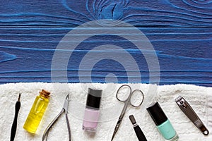 Nail polish and manicure set on dark wooden background