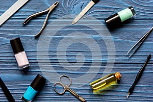 Nail polish and manicure set on dark wooden background