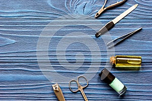 Nail polish and manicure set on dark wooden background