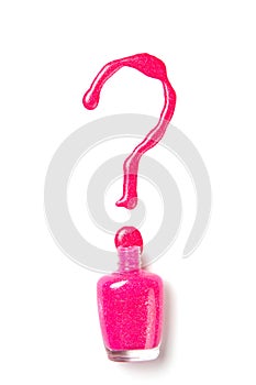 Nail polish of pink color in the form of a question mark on a white isolated background