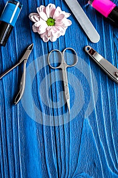 Nail polish and spa manicure set on dark wooden background