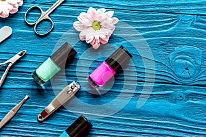 Nail polish and spa manicure set on dark wooden background