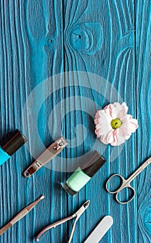 Nail polish and spa manicure set on dark wooden background