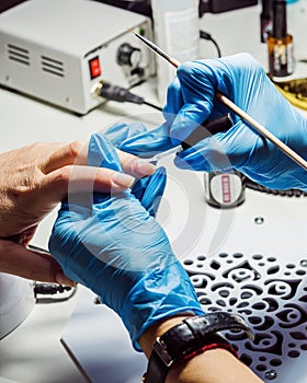 Nail salon, applying colorless varnish on the nails