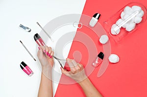 Nail salon. Beautiful female hands with pink manicure.