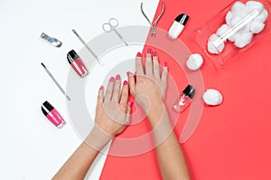 Nail salon. Beautiful female hands with pink manicure.