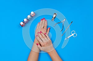 Nail salon. Beautiful female hands with pink manicure.