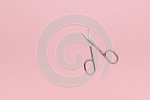 Nail scissors on pink. A place for your text