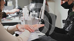 Nail service. Woman getting her nails done at the salon, close-up