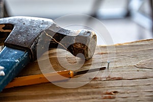 Nail set punch with hammer on wooden board