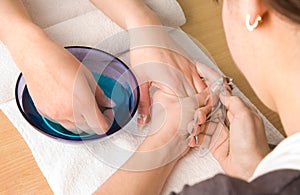 Nail studio. Woman in manicure procedures.