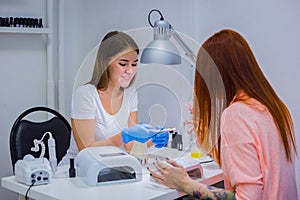 Nail technician shows the color palette of nail services in beau