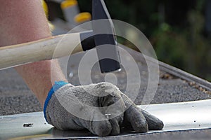 Nailing nails with a hammer in hand