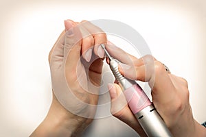 Nails Beauty. Closeup Of Woman Hands Receiving Nail Care Treatment.Manicurist Hands Cutting Cuticle On Nails With Nail Clippers