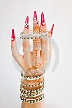 Nails decorated with brilliant and hand with henna tattoos