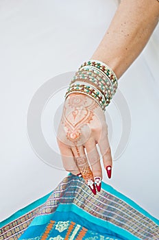 Nails decorated with brilliant and hand with henna tattoos