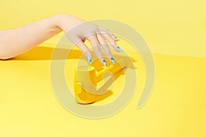 Nails Design. Hand With Colorful Nails On Yellow Background