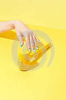 Nails Design. Hand With Colorful Nails On Yellow Background