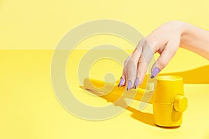 Nails Design. Hand With Colorful Nails On Yellow Background