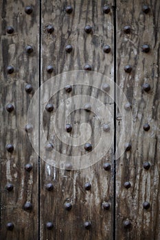 Nails driven into wooden boards, wooden background