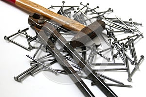 Nails, hammer and pincers on a white background