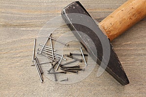Nails and hammer on wooden table