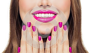 Nails and lips. Woman touching her cheeks her hands with manicure nails. Pink color lipstick and nail polish
