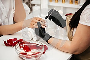 Nails manicure with file or brush nail care process. Clipping nails, hand care and nailcare at beauty salon photo