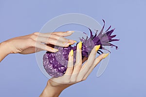 Nails Manicure. Hand With Stylish Nails Holding Purple Pineapple