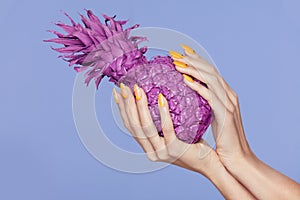 Nails Manicure. Hand With Stylish Nails Holding Purple Pineapple