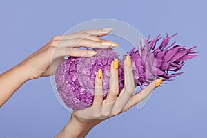 Nails Manicure. Hand With Stylish Nails Holding Purple Pineapple