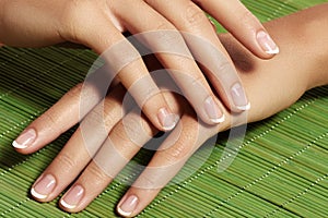 Nails with perfect french manicure. Care for female hands.