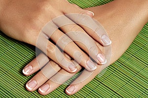 Nails with perfect french manicure. Care for female hands.