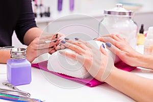 Nails saloon woman nail polish remove with tissue