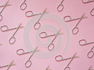 Nails scissors pattern on pink
