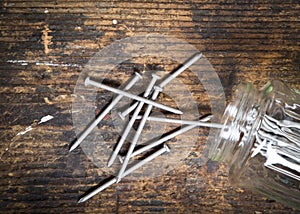 Nails spilling from a jar