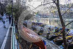 The colorful boats in beautiful Nainital lake in the morning, waiting for travelers.