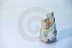 Naira notes in a bottle with white background