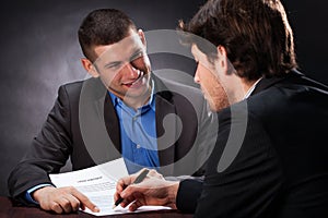 Naive man signing the usury contract