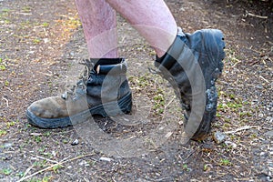 Naked male feet dressed in old shoes