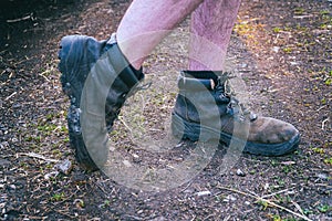 Naked male feet dressed in old shoes