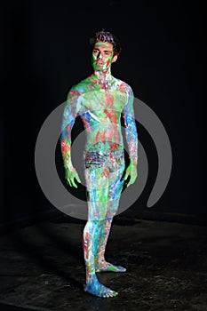 Naked man covered in paint in the