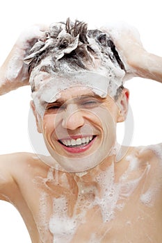 Naked man with shampoo over hair photo