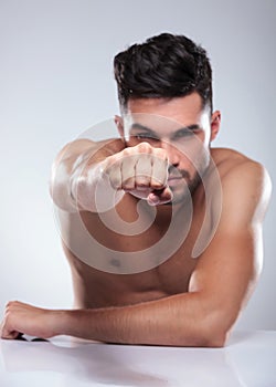 Naked man throwing a punch