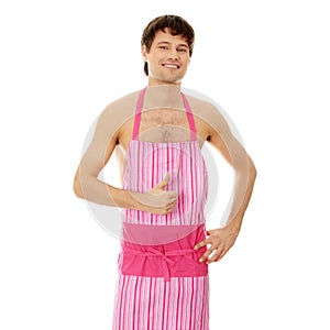 Naked man wering pink apron