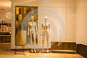 naked mannequins in fashion shop window