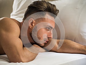 naked muscular young man on bed