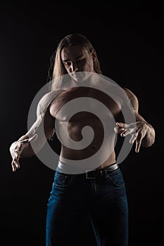 Naked torso male bodybuilder athlete with long blond hair in studio