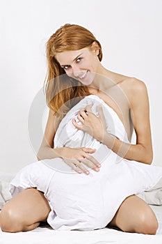 Naked woman covered by the blanket photo