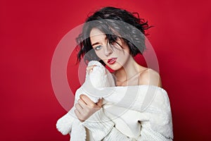 Naked woman with short hair. Girl posing in a white jacket on a red background. Perfect clean skin, Nude body of